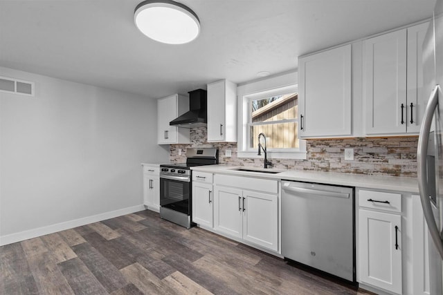 N5599 Mill St, Shiocton, WI 54170 - kitchen featuring wall chimney exhaust hood, stainless steel appliances, a sink, dark wood-style flooring, and visible vents