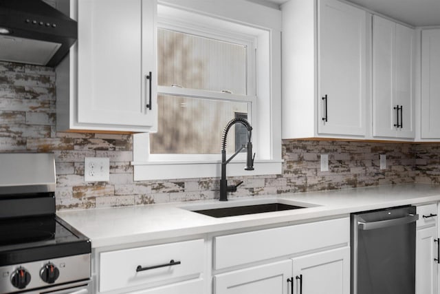 N5599 Mill St, Shiocton, WI 54170 - kitchen with a sink, tasteful backsplash, white cabinetry, under cabinet range hood, and appliances with stainless steel finishes