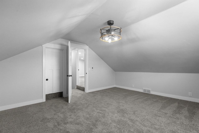 N5599 Mill St, Shiocton, WI 54170 - bonus room featuring lofted ceiling, carpet flooring, visible vents, and baseboards