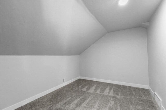 N5599 Mill St, Shiocton, WI 54170 - bonus room with vaulted ceiling, visible vents, baseboards, and carpet