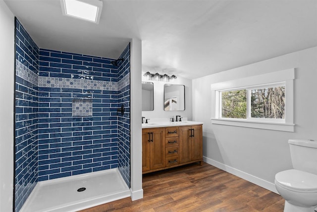 N5599 Mill St, Shiocton, WI 54170 - full bath with a sink, double vanity, toilet, baseboards, and wood finished floors
