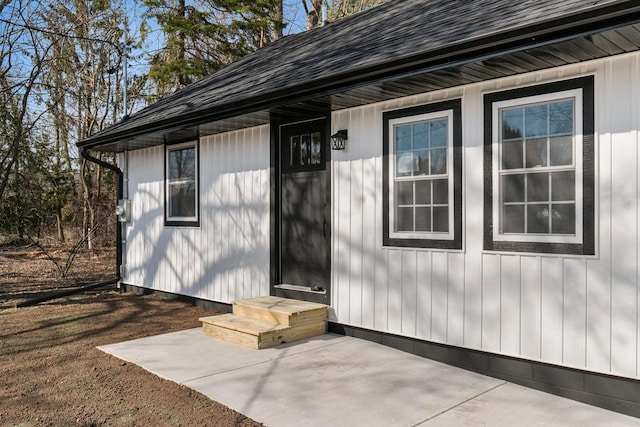 N5599 Mill St, Shiocton, WI 54170 - doorway to property with roof with shingles and a patio
