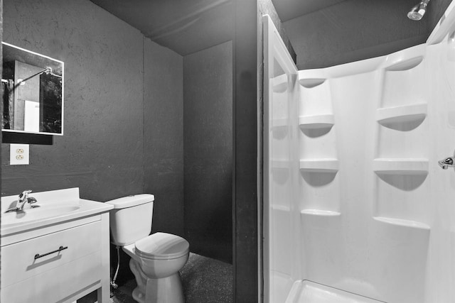 N5599 Mill St, Shiocton, WI 54170 - bathroom featuring toilet, vanity, a textured wall, and a stall shower