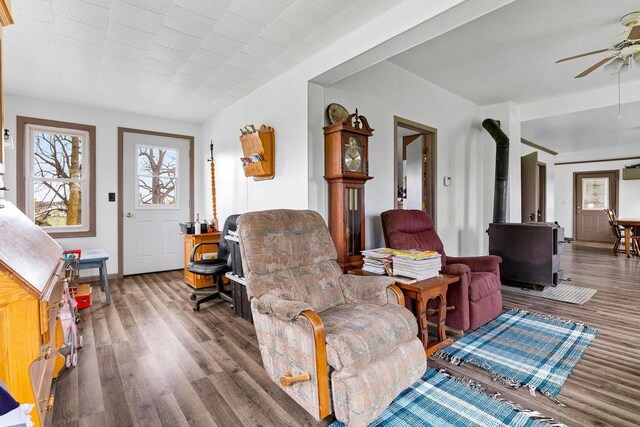 N2226 State Road 57, New Holstein, WI 53061 - living area featuring a ceiling fan, wood finished floors, and a wood stove