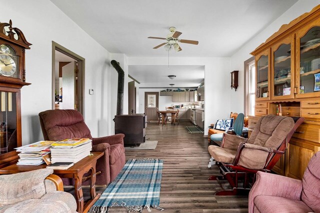 N2226 State Road 57, New Holstein, WI 53061 - living area featuring dark wood-style flooring, a ceiling fan, and a wood stove