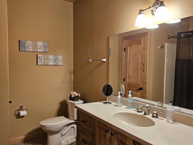 bathroom featuring tile patterned flooring, toilet, and vanity