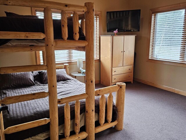 carpeted bedroom with baseboards