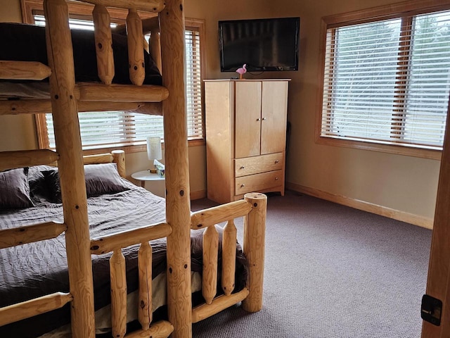 carpeted bedroom with baseboards