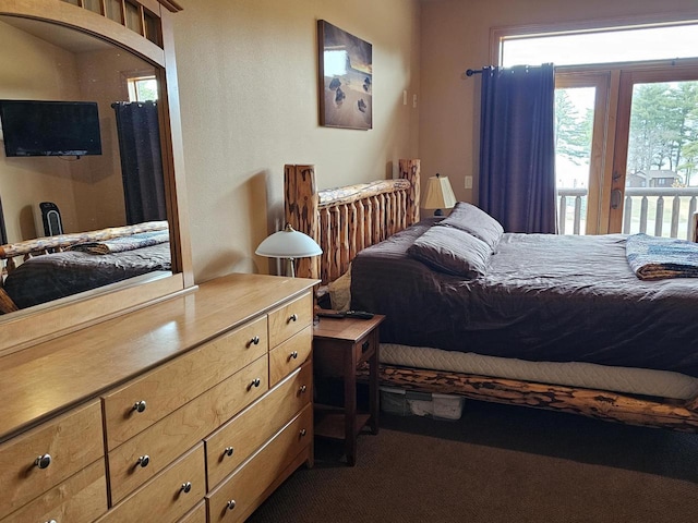 bedroom with dark colored carpet and access to exterior