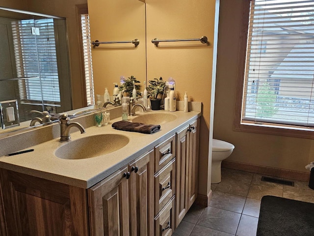 full bath featuring visible vents, tile patterned floors, toilet, and a sink