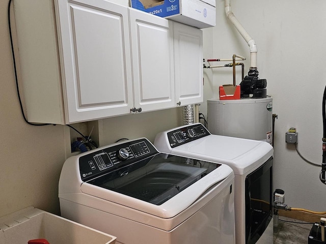 washroom with cabinet space, water heater, and washing machine and clothes dryer