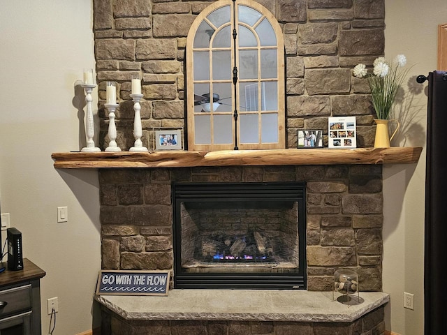 room details featuring a fireplace and baseboards