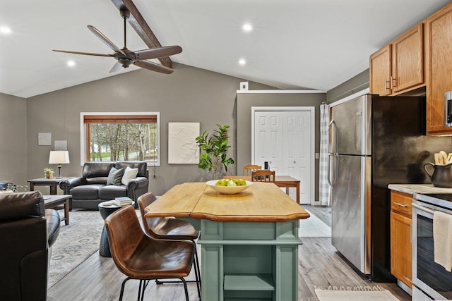 W9517 Parkway Dr, Poynette, WI 53955 - kitchen with ceiling fan, open floor plan, appliances with stainless steel finishes, and light wood-style flooring