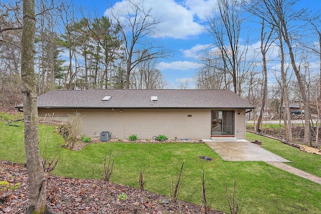W9517 Parkway Dr, Poynette, WI 53955 - back of house with a lawn, roof with shingles, central AC unit, and a patio area