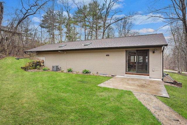 W9517 Parkway Dr, Poynette, WI 53955 - back of property featuring a patio, a shingled roof, cooling unit, and a yard