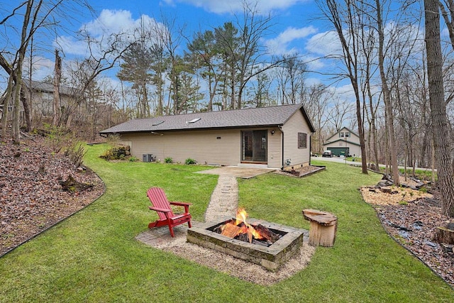 W9517 Parkway Dr, Poynette, WI 53955 - back of house with a lawn, an outdoor fire pit, a patio area, and central air condition unit