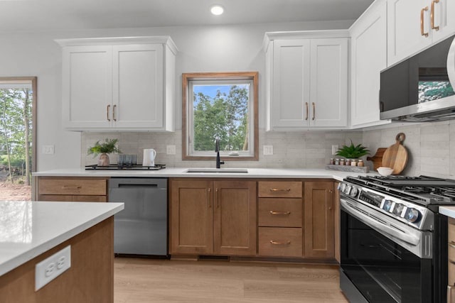 3216 Eclipse Dr, Green Bay, WI 54311 - kitchen featuring appliances with stainless steel finishes, light countertops, tasteful backsplash, white cabinetry, and recessed lighting