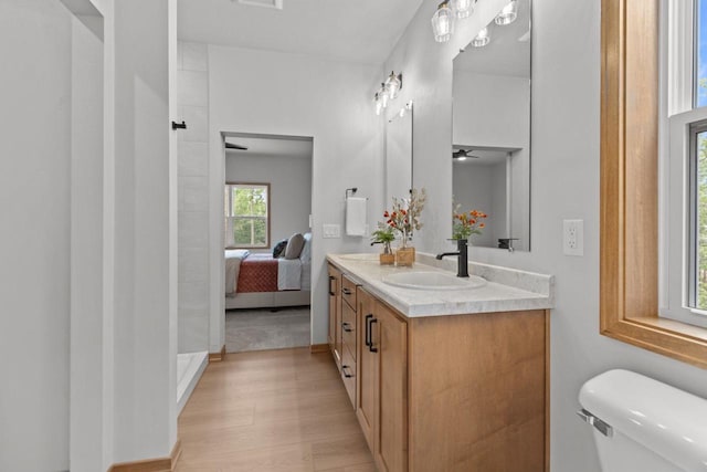 3216 Eclipse Dr, Green Bay, WI 54311 - bathroom featuring vanity, walk in shower, ceiling fan, wood finished floors, and ensuite bathroom