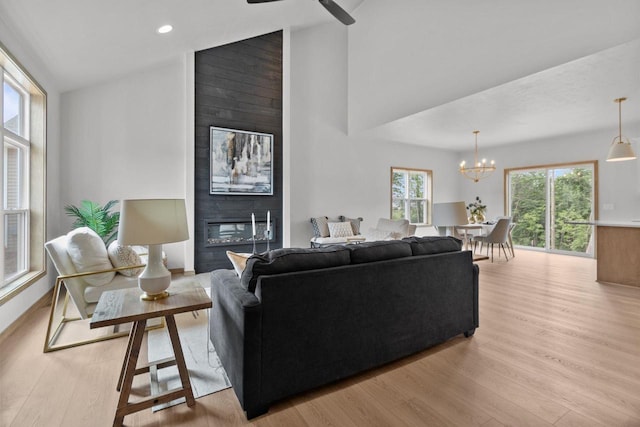 3216 Eclipse Dr, Green Bay, WI 54311 - living room featuring light wood-type flooring, a chandelier, ceiling fan, a large fireplace, and recessed lighting