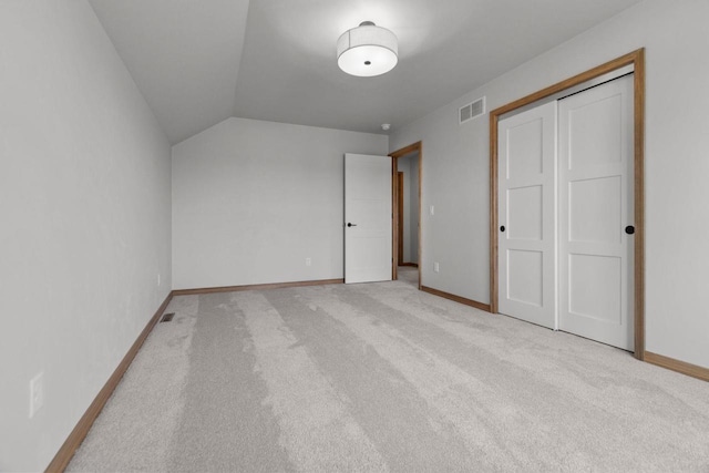 3216 Eclipse Dr, Green Bay, WI 54311 - unfurnished bedroom featuring carpet floors, vaulted ceiling, and a closet