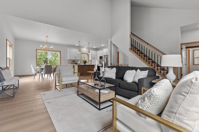 3216 Eclipse Dr, Green Bay, WI 54311 - living area featuring a chandelier, light wood-style floors, and stairs
