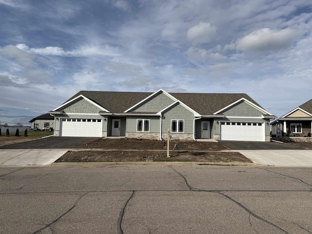 3131 S Bartells Dr, Beloit, WI 53511 - ranch-style house featuring an attached garage, stone siding, and driveway