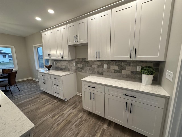 3131 S Bartells Dr, Beloit, WI 53511 - kitchen with dark wood-style floors, tasteful backsplash, baseboards, recessed lighting, and white cabinetry