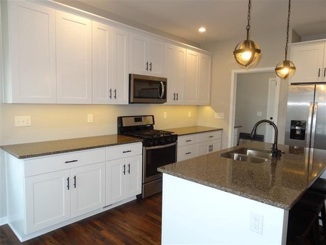 3131 S Bartells Dr, Beloit, WI 53511 - kitchen with white cabinets, a sink, dark wood-style floors, recessed lighting, and stainless steel appliances