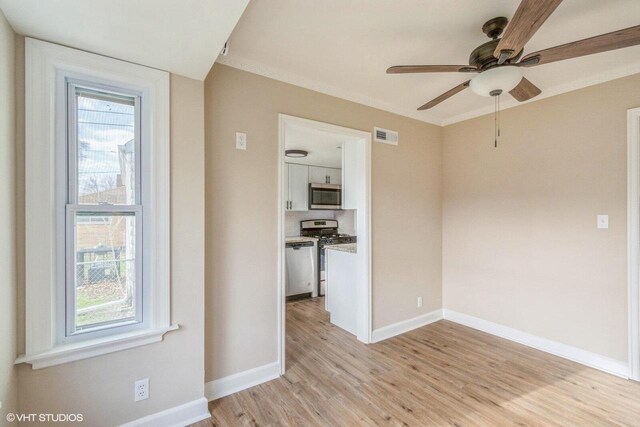 4858 N 73rd St, Milwaukee, WI 53218 - spare room with light wood-type flooring, ornamental molding, baseboards, and ceiling fan