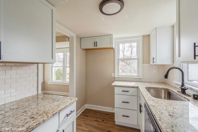 4858 N 73rd St, Milwaukee, WI 53218 - kitchen featuring dark wood finished floors, decorative backsplash, light stone counters, and a sink