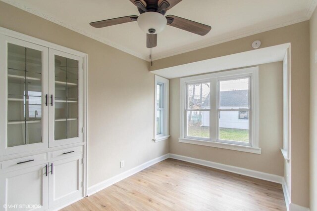 4858 N 73rd St, Milwaukee, WI 53218 - empty room with light wood finished floors, crown molding, baseboards, and a ceiling fan