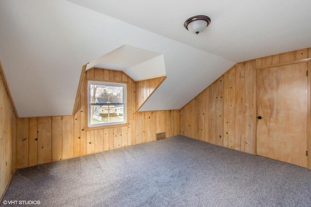 4858 N 73rd St, Milwaukee, WI 53218 - bonus room featuring lofted ceiling, wooden walls, and carpet floors