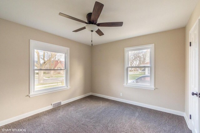 4858 N 73rd St, Milwaukee, WI 53218 - spare room featuring dark colored carpet, visible vents, baseboards, and ceiling fan
