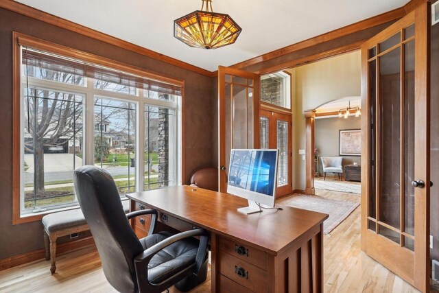 1310 Hanover Ct, Waunakee, WI 53597 - home office with plenty of natural light, french doors, and light wood-style floors