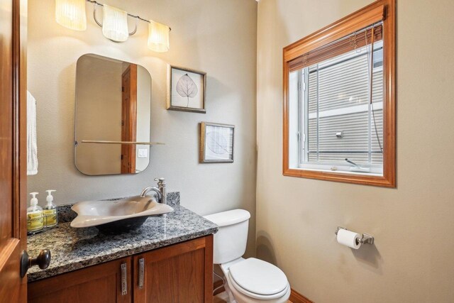 1310 Hanover Ct, Waunakee, WI 53597 - half bathroom featuring vanity and toilet