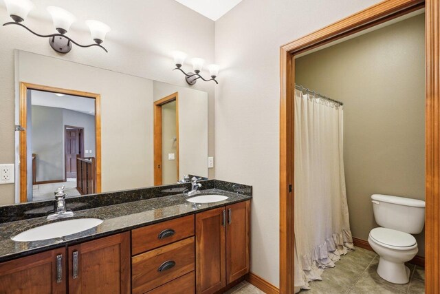 1310 Hanover Ct, Waunakee, WI 53597 - full bathroom with a sink, double vanity, and toilet