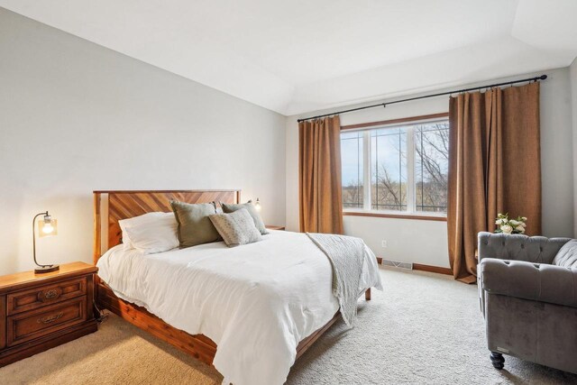 1310 Hanover Ct, Waunakee, WI 53597 - bedroom featuring vaulted ceiling, visible vents, baseboards, and light carpet