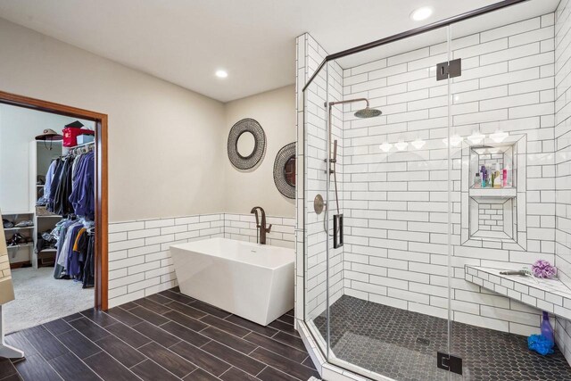 1310 Hanover Ct, Waunakee, WI 53597 - full bath featuring tile walls, a freestanding tub, recessed lighting, and a stall shower