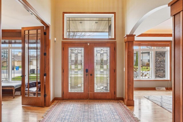 1310 Hanover Ct, Waunakee, WI 53597 - doorway featuring arched walkways, wood finished floors, visible vents, and french doors