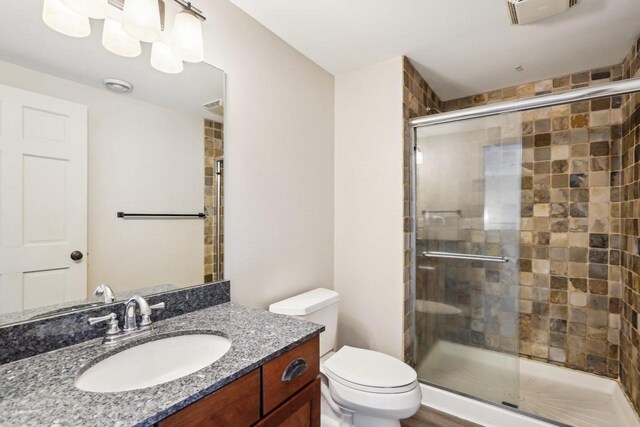 1310 Hanover Ct, Waunakee, WI 53597 - bathroom with toilet, visible vents, vanity, and a stall shower