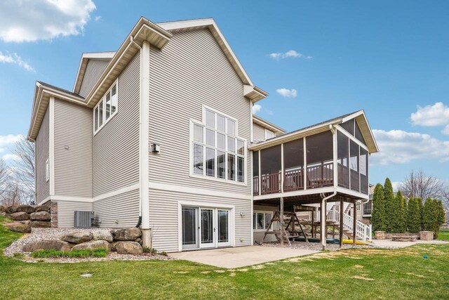 1310 Hanover Ct, Waunakee, WI 53597 - rear view of property featuring stairs, a yard, cooling unit, a patio area, and a sunroom
