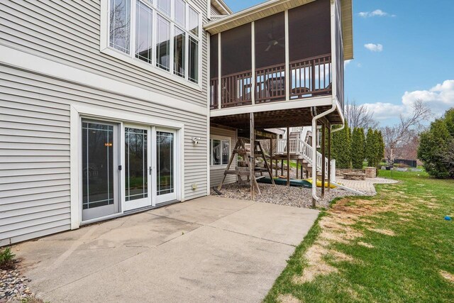 1310 Hanover Ct, Waunakee, WI 53597 - back of house with a lawn, a sunroom, stairway, and a patio
