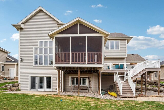 1310 Hanover Ct, Waunakee, WI 53597 - rear view of house featuring a yard, a sunroom, stairs, and a deck