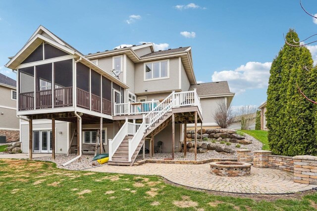 1310 Hanover Ct, Waunakee, WI 53597 - back of house with an outdoor fire pit, a patio, a wooden deck, a sunroom, and stairs