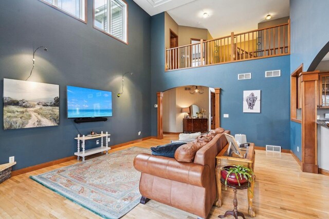 1310 Hanover Ct, Waunakee, WI 53597 - living area with arched walkways, wood finished floors, and visible vents