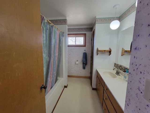 N14341 Fairground Ave, Owen, WI 54460 - bathroom featuring wallpapered walls, baseboards, vanity, and shower / tub combo with curtain