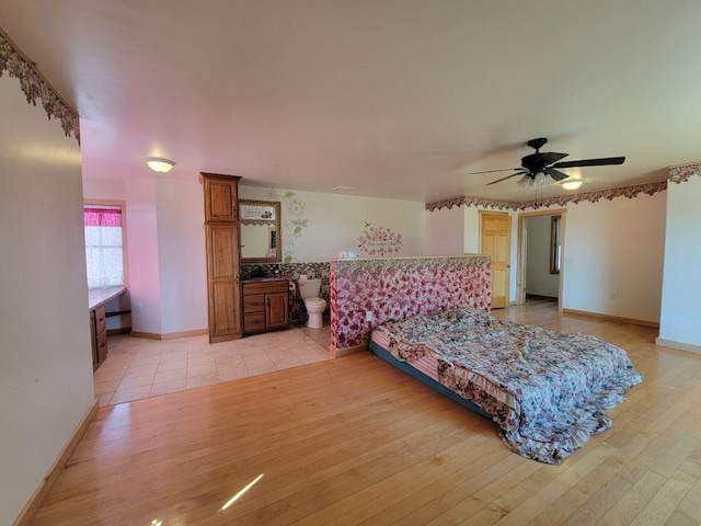 N14341 Fairground Ave, Owen, WI 54460 - bedroom featuring light wood-style flooring, a ceiling fan, baseboards, and connected bathroom