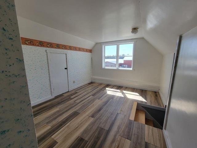 N14341 Fairground Ave, Owen, WI 54460 - bonus room featuring vaulted ceiling, wood finished floors, wallpapered walls, and baseboards
