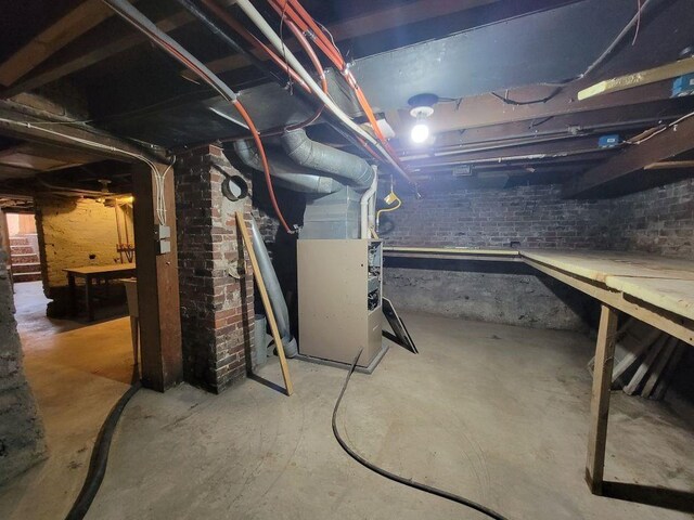 N14341 Fairground Ave, Owen, WI 54460 - unfinished basement featuring brick wall and heating unit