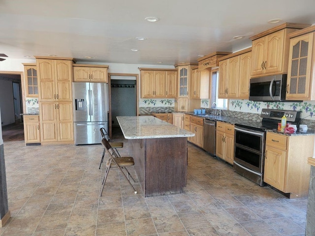 N14341 Fairground Ave, Owen, WI 54460 - kitchen with a sink, stone counters, recessed lighting, a kitchen island, and appliances with stainless steel finishes